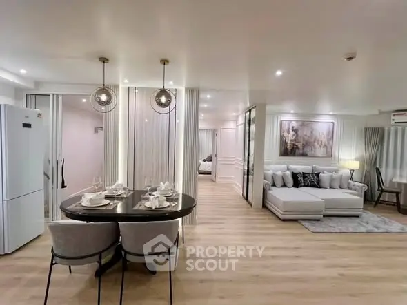 Luxurious open-plan living room with elegant dining area and modern decor
