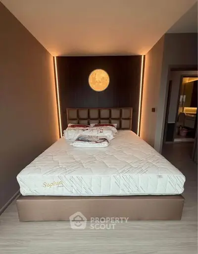 Modern bedroom with stylish lighting and comfortable bed