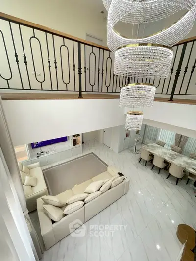 Luxurious open-plan living room with elegant chandelier and modern decor