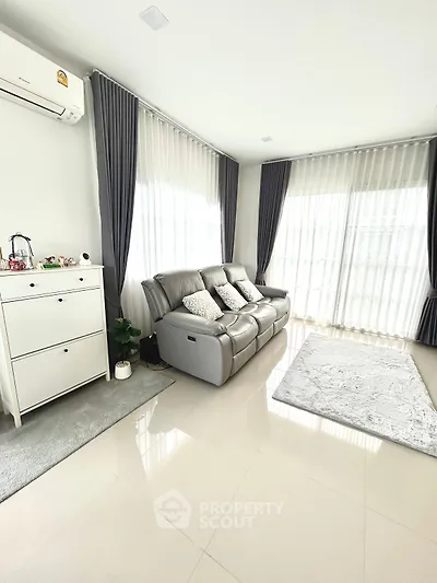 Spacious living room with modern sofa and natural light