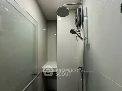 Modern bathroom with sleek shower fixtures and glass partition
