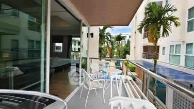 Modern balcony with pool view in a stylish apartment complex