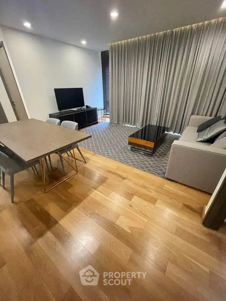 Modern living room with sleek furniture and wooden flooring