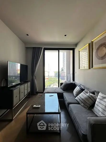 Modern living room with large window and stylish decor in urban apartment