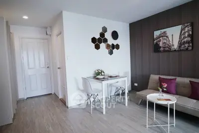 Modern living room with stylish decor and dining area in a cozy apartment.