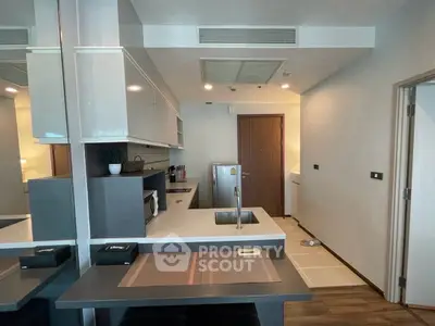 Modern kitchen with sleek cabinetry and compact design in a contemporary apartment.