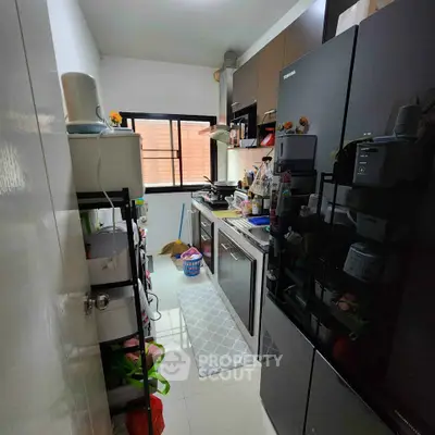 Compact kitchen with modern appliances and ample storage space, perfect for efficient cooking and organization.