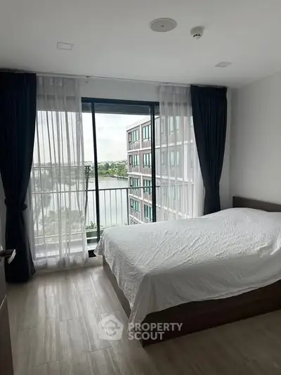 Bright bedroom with large window and scenic view in modern apartment