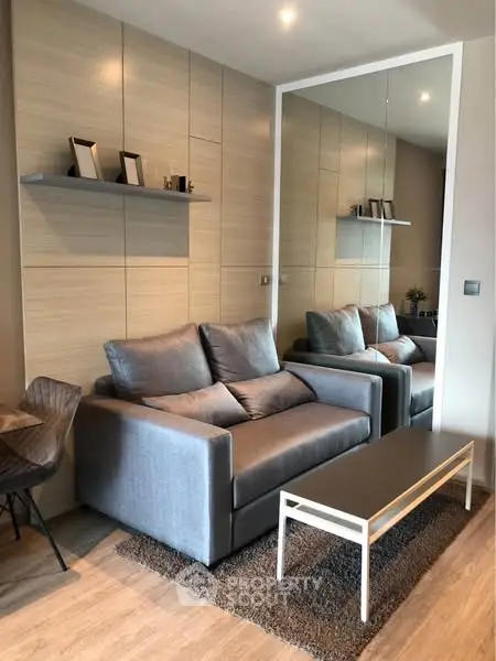 Modern living room with stylish gray sofa and sleek decor