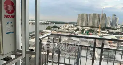Stunning cityscape view from a high-rise balcony overlooking river and skyline.
