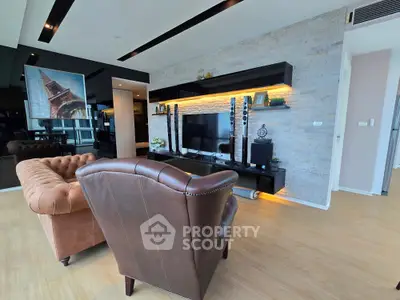 Luxurious living room with modern decor, leather seating, and stylish entertainment center.