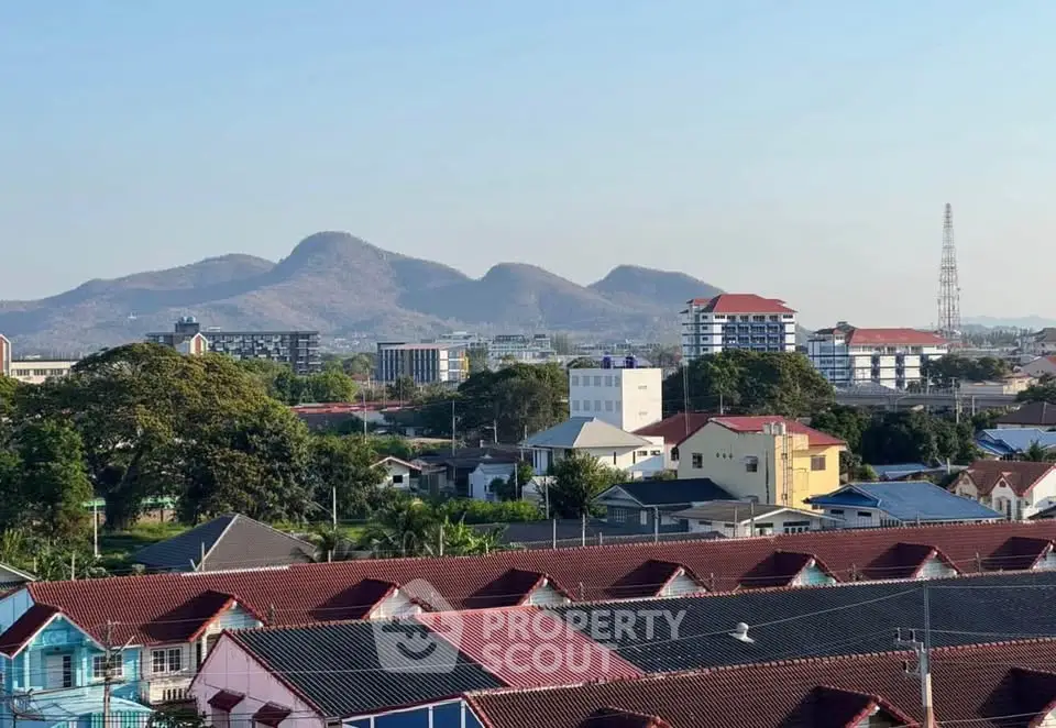 Scenic view of suburban neighborhood with mountain backdrop and diverse architecture.