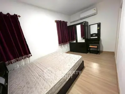 Spacious bedroom with modern furniture and air conditioning
