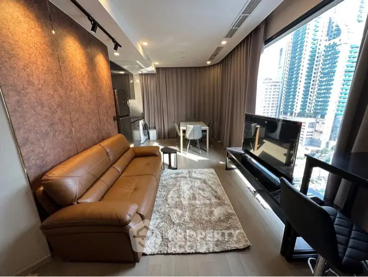 Modern living room with leather sofa and city view, featuring sleek design and ample natural light.