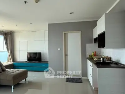 Modern living room with sleek kitchen and stylish decor