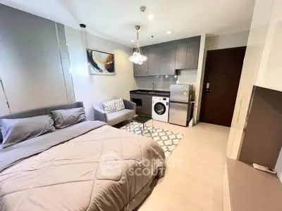 Modern studio apartment with cozy bed, compact kitchen, and stylish decor