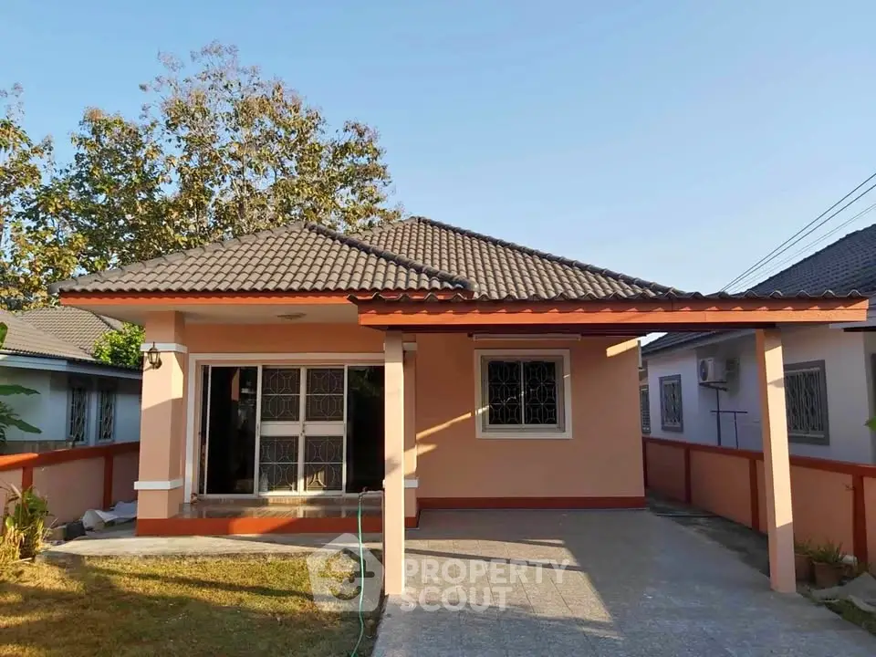 Charming single-story house with tiled roof and spacious driveway in a serene neighborhood.
