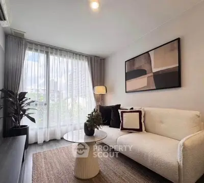 Stylish modern living room with cozy sofa and large window view