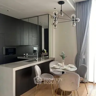 Modern kitchen with sleek black cabinetry and elegant dining area in a stylish apartment.
