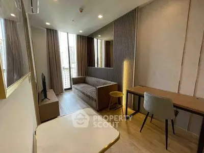 Modern living room with stylish decor and city view, featuring a cozy sofa and elegant workspace.