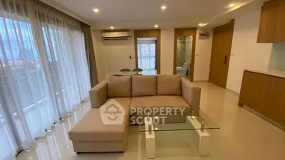 Spacious modern living room with large windows and elegant furniture