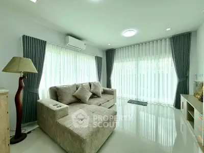 Spacious living room with modern decor and large windows for natural light.
