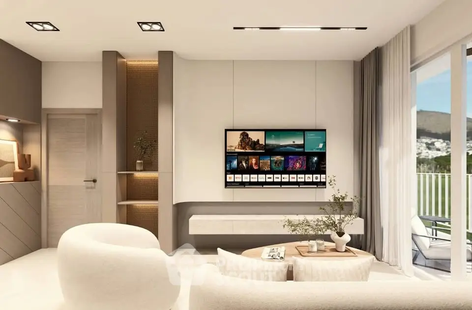 Modern living room with sleek design, featuring a wall-mounted TV, stylish furniture, and large windows with scenic views.
