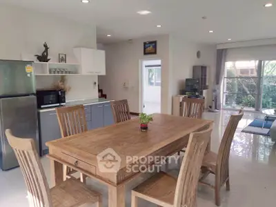 Spacious open-plan kitchen and dining area with modern appliances and natural light.