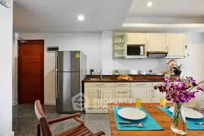 Modern kitchen with stainless steel fridge and elegant dining setup