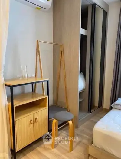 Modern bedroom with stylish wooden furniture and built-in wardrobe, perfect for cozy living.