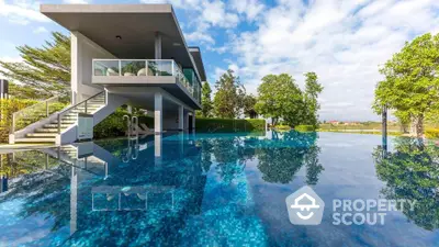 Luxurious modern house with stunning pool and lush greenery, perfect for relaxation and entertainment.