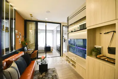 Modern living room with stylish decor and open layout leading to bedroom