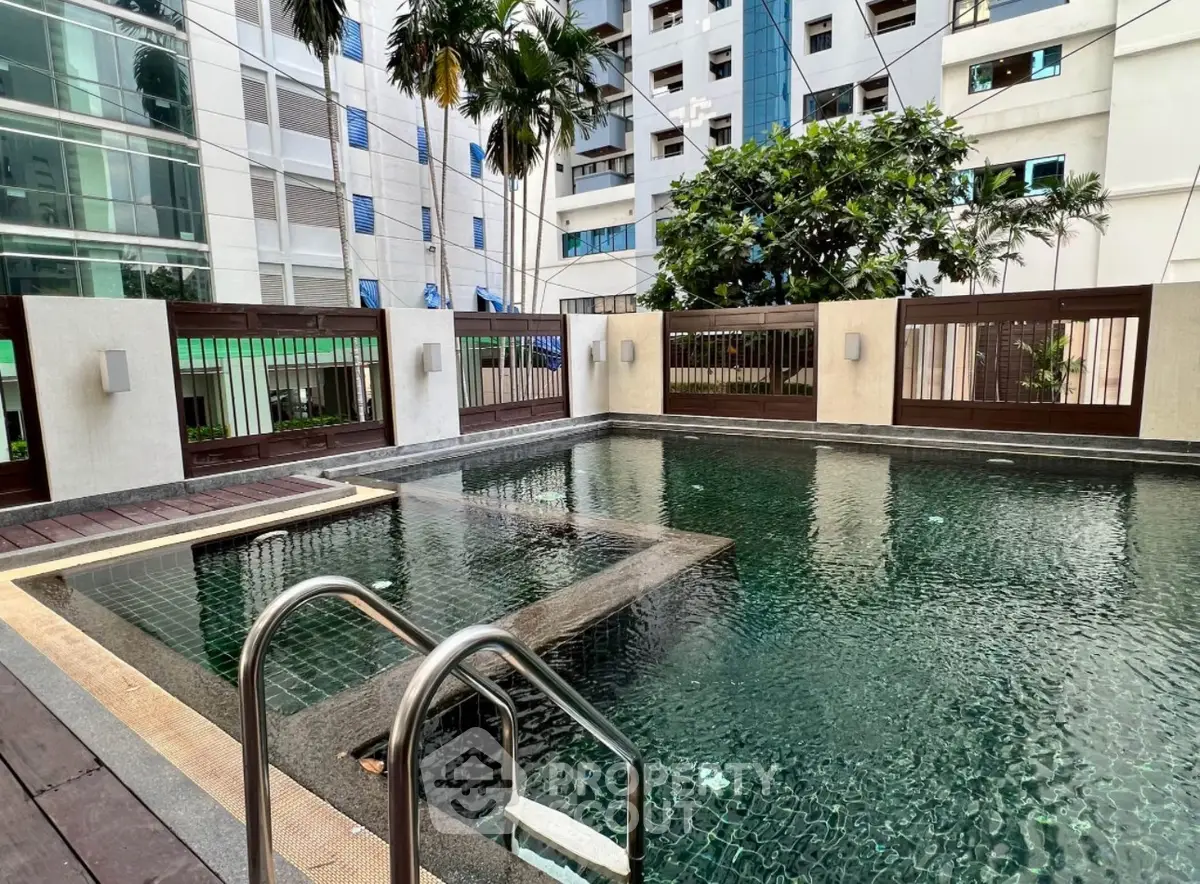 Luxurious residential pool area with modern design and lush greenery