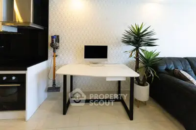 Modern living room with sleek desk, computer, and stylish decor