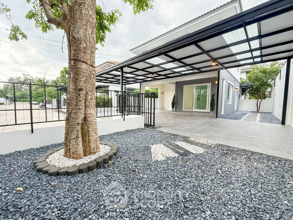 Modern home exterior with spacious driveway and elegant landscaping