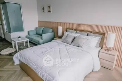 Modern bedroom with stylish decor and cozy seating area