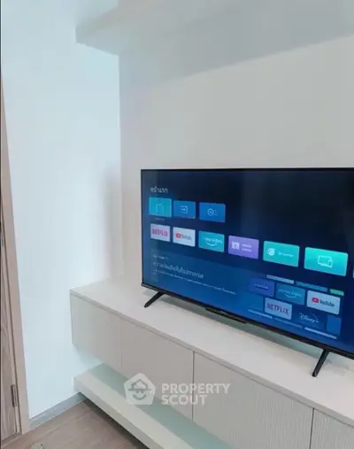 Modern living room with sleek TV setup and stylish storage unit