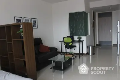 Spacious and modern living room with sleek furniture, glossy tiled flooring, and a cozy study corner featuring a blackboard, ideal for relaxation or work from home setup.