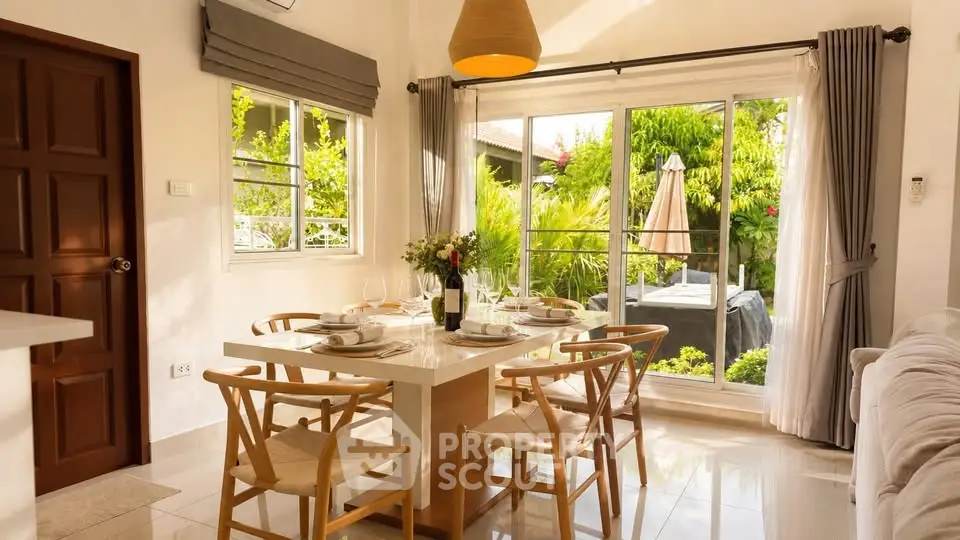 Bright dining area with modern furniture and garden view, perfect for family gatherings.