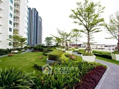 Luxurious residential building with lush landscaped garden and modern architecture.