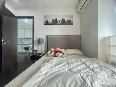 Cozy bedroom with modern decor and air conditioning, featuring a comfortable bed and stylish artwork.