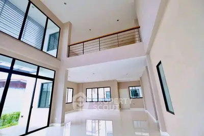 Spacious modern living room with high ceilings and large windows for natural light.