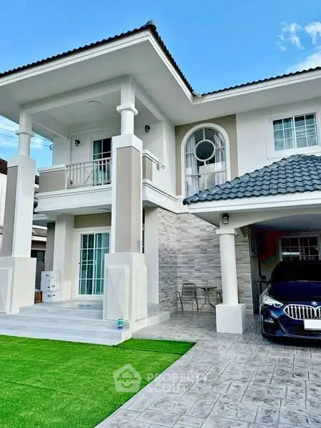 Stunning two-story house with modern design, spacious driveway, and lush green lawn.