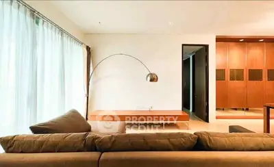 Spacious modern living room with elegant lighting and stylish furniture, perfect for relaxation and entertaining.