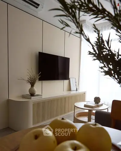 Modern living room with wall-mounted TV and stylish decor