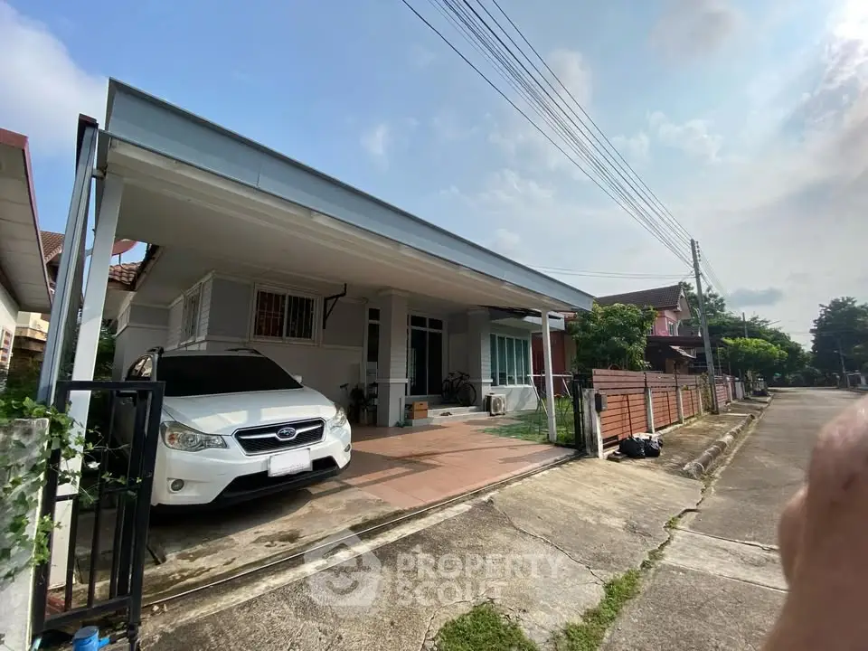 Charming suburban home with carport and spacious driveway in a peaceful neighborhood.