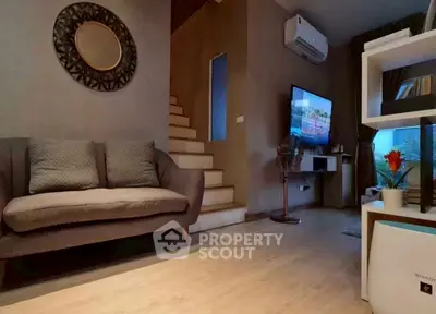 Cozy living room with modern decor and staircase