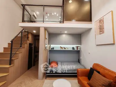 Modern loft apartment with mezzanine, cozy living area, and stylish decor