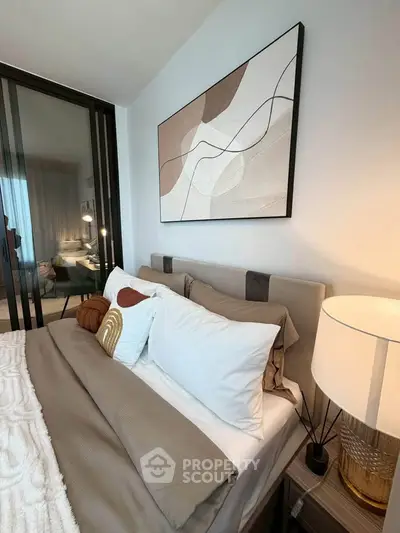 Modern bedroom with stylish decor and cozy bedding in a contemporary apartment.