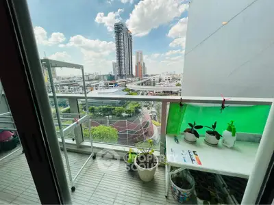Charming balcony with city view, perfect for urban gardening enthusiasts.